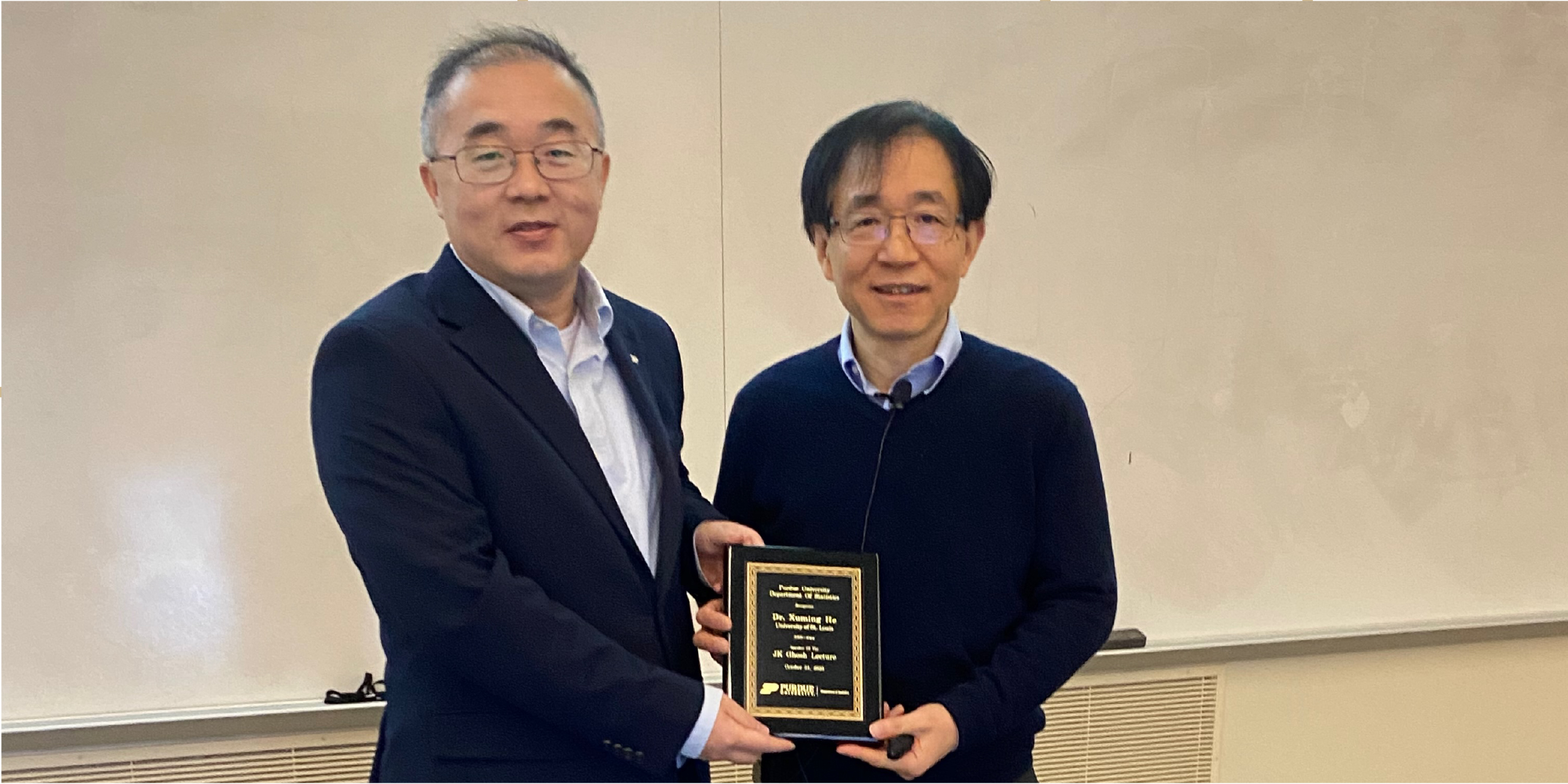 Xiao Wang presents Xuming He with a plaque recognizing him as the JK Ghosh lecturer for 2025.