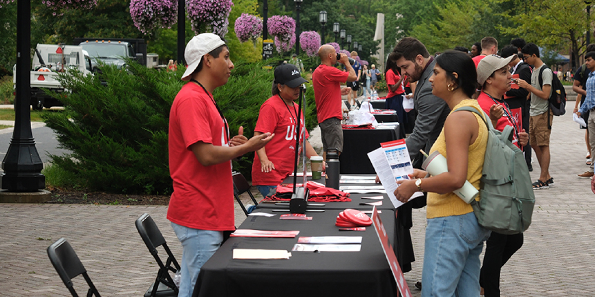 Purdue students talk to Lilly representatives at outdoor tables