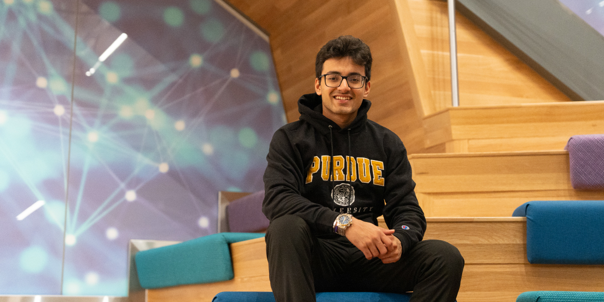 Shlok Sheth sits ion steps nside the DSAI building on the Purdue University campus